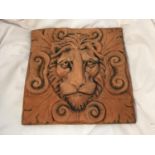 A TERRACTTA STONE WALL PLAQUE DEPICTING A LIONS HEAD 30CM X 30CM