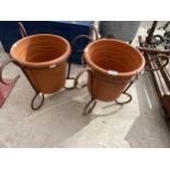 A PAIR OF WROUGHT IRON PLANT POT HOLDERS