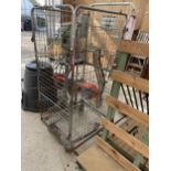 A VINTAGE METAL LAUNDRY CAGE ON WHEELS