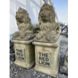 A PAIR OF RECONSTITUTED STONE CROUCHING LIONS TO INCLUDE TO STONE PEDASTAL BASE BEARING A PLAQUE '