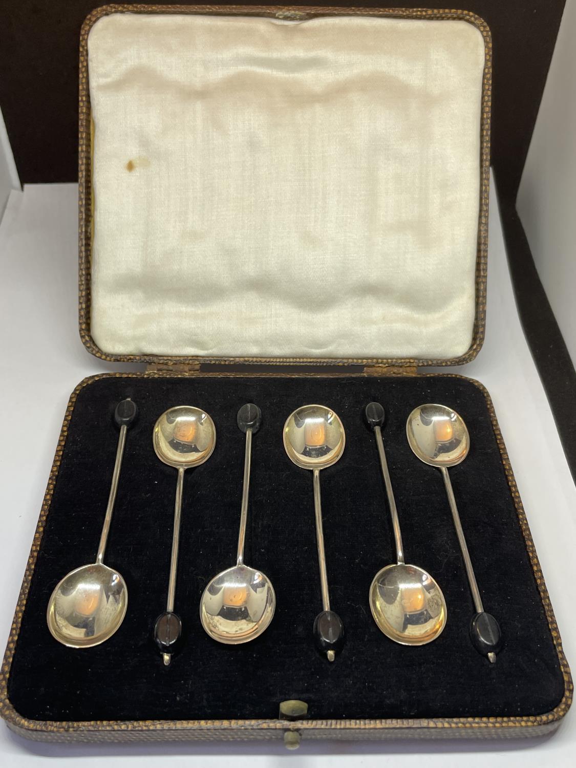 A BOXED SET OF SIX HALLMARKED SHEFFIELD COFFEE BEAN SPOONS