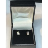 A PAIR OF 9 CARAT GOLD EARRINGS WITH RECTANGULAR CLEAR STONES IN A PRESENTATION BOX