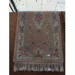 A CREAM PATTERNED FRINGED RUG