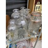 A COLLECTION OF FOUR GLASS DEMI JOHNS, TWO GLASS DOMES AND A KILNER JAR WITH A TAP