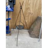 A VINTAGE CAST IRON SKILLET PAN ON A TRIPOD STAND