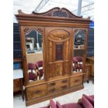 A VICTORIAN WALNUT MIRRORED DOOR WARDROBE WITH TWO HANGING SECTIONS, FOUR DRAWERS TO THE BASE AND