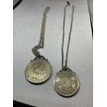 TWO MOUNTED COINS ON SILVER CHAINS TO INCLUDE A FIVE SHILLINGS AND A HALF CROWN