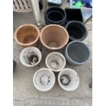 A LARGE ASSORTMENT OF CERAMIC AND PLASTIC PLANT POTS TO INCLUDE TERRACOTTA EXAMPLES