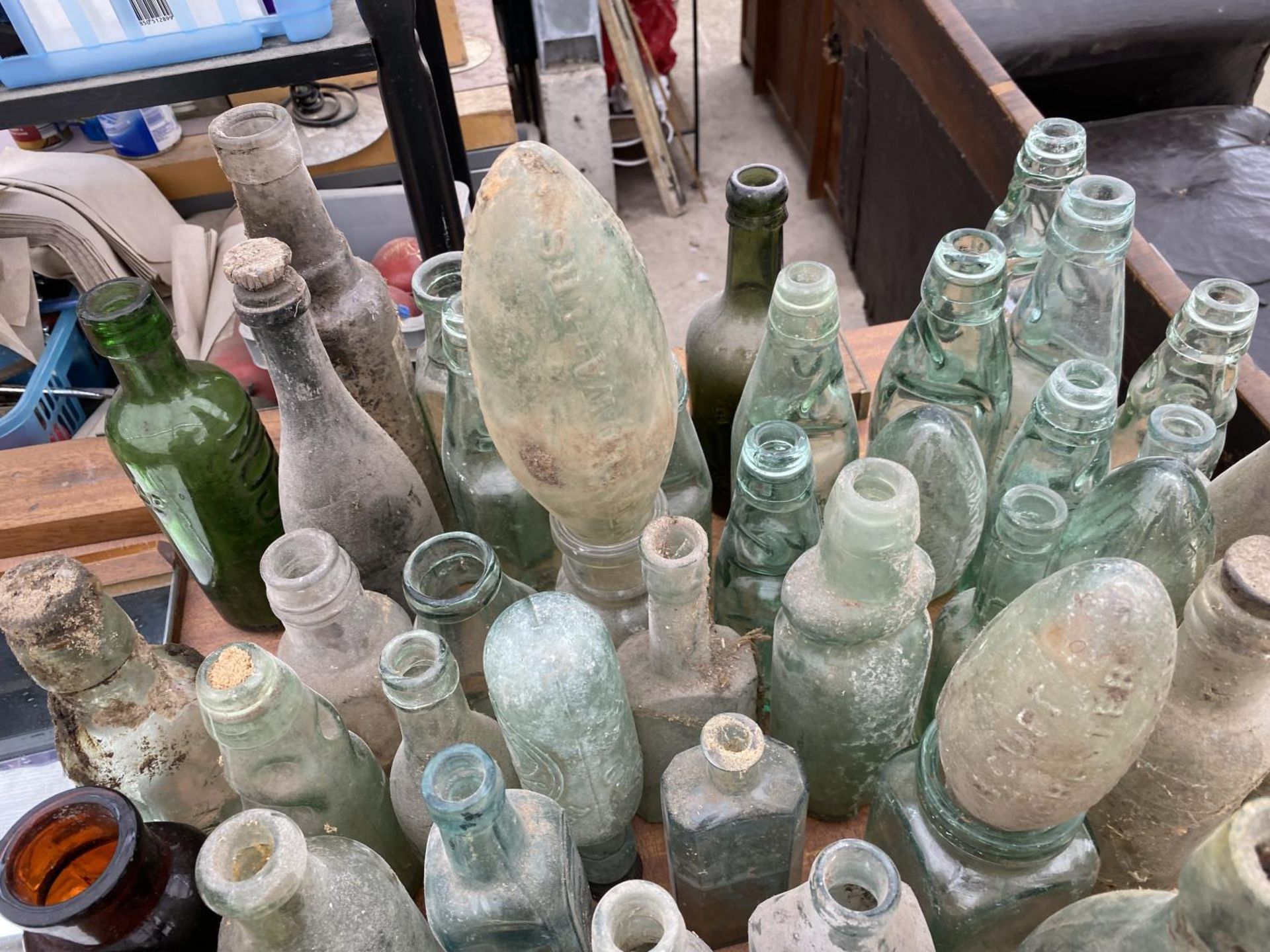 A LARGE QUANTITY OF VINTAGE GLASS BOTTLES SOME BEARING NAMES - Image 3 of 3