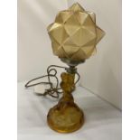 AN ART DECO STYLE AMBER COLOURED GLASS LAMP WITH THE BASE IN THE FORM OF A LADY AND A GEOMETRIC