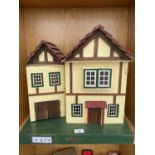 A SMALL WOODEN DOLLS HOUSE