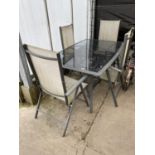 A GLASS TOPPED GARDEN TABLE AND FOUR FOLDING CHAIRS