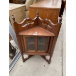 A VICTORIAN CORNER CABINET WITH BEVEL GLASS TO THE DOOR