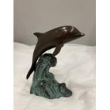 A BRONZED DOLPHIN RIDING A WAVE HEIGHT 16CM