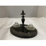 AN OVAL OAK INK STAND WITH GLASS INKWELLS