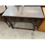 AN EARLY 20TH CENTURY OAK JACOBEAN STYLE TWO DRAWER SIDE-TABLE ON BULBOUS LEGS, 42" WIDE