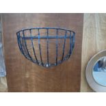 A WROUGHT IRON HAY RACK PLANTER