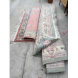A LARGE GREEN PATTERN RUG AND A LARGE PINK PATTERN RUG