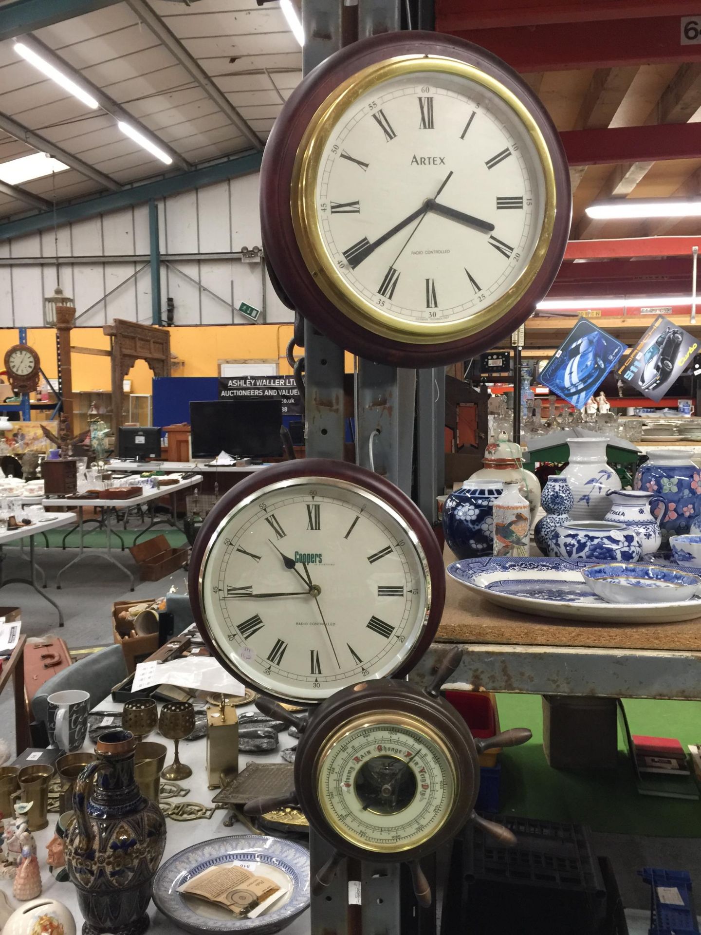 TWO WALL CLOCKS (COOPERS AND ARTEX) AND A SMALL SHIPS WHEEL BAROMETER, MISSING ONE OF THE SPOKES