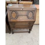 AN EARLY 20TH CENTURY OAK JACOBEAN STYLE BUREAU, 29.5" WIDE