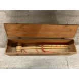 A BOXED TRI-ANG CROQUET SET CONTAINING 1 MALLET, 1 PEG AND FIVE HOOPS