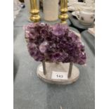 A PIECE OF AMETHYST ON A STAND