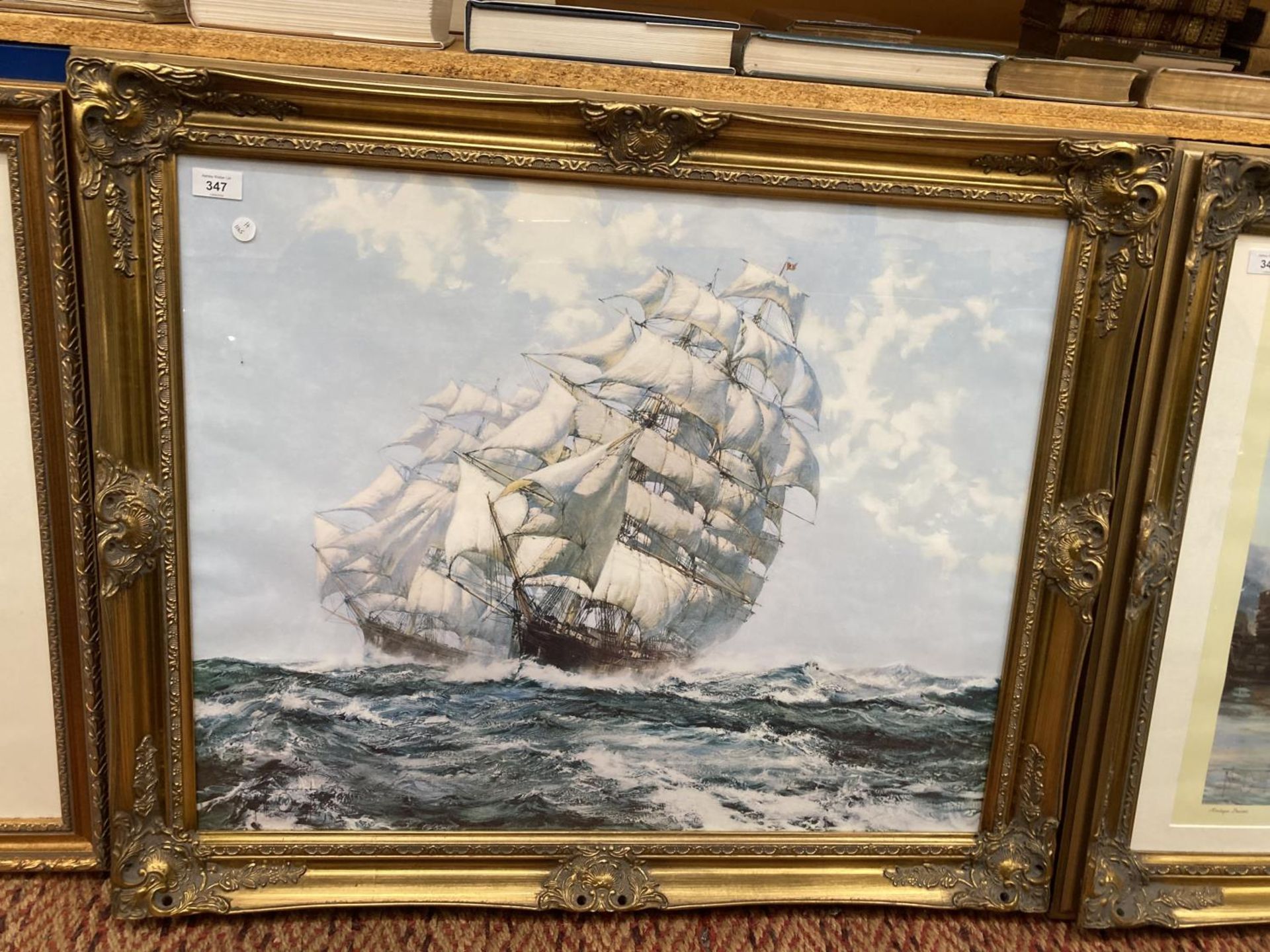 A LARGE ORNATE EMBOSSED GILT FRAMED PRINT OF TWO CLIPPER SHIPS IN ROUGH SEAS BY MONTAGUE DAWSON W: