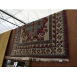 A RED PATTERNED FRINGED RUG