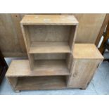 A LIMED OAK STEPPED OPEN BOOKCASE WITH SINGLE CUPBOARD, BY HEAL'S OF LONDON, 33" WIDE