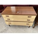 A RETRO TEAK AND CREAMY WALNUT CHEST OF THREE DRAWERS, 36" WIDE