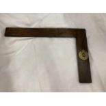 A WOODEN SET SQUARE WITH A ROYAL ENGINEERS MILITARY BADGE