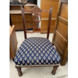 AN EDWARDIAN LOW NURSING CHAIR