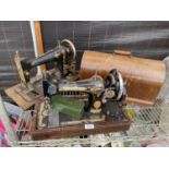 TWO VINTAGE SINGER SEWING MACHINES, ONE WITH A WOODEN CARRY CASE TO ALSO INCLUDE A SINGER TIN