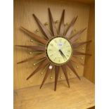 A DECORATIVE WOODEN WALL CLOCK