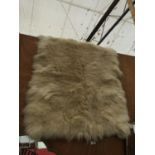A SMALL SHEEP SKIN STYLE RUG