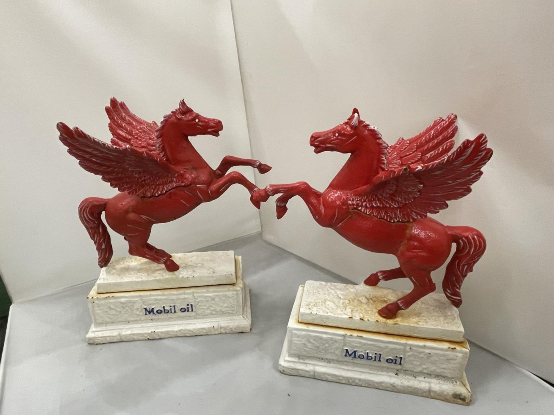 A PAIR OF HEAVY CAST MOBIL OIL PEGASUS STATUES HEIGHT 34CM LENGTH LENGTH 29CM