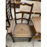 AN EARLY 20TH CENTURY BARLEYTWIST ELBOW CHAIR WITH RUSH SEATS