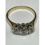 A 9 CARAT GOLD RING WITH THREE IN LINE CLEAR STONES