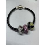 A PANDORA LEATHER AND SILVER BRACELET WITH THREE COLOURED CHARMS IN A PRESENTATION BOX