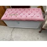 A MODERN PADDED TOP OTTOMAN