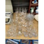 A LARGE ASSORTMENT OF GLASS WARE TO INCLUDE SHERRY GLASSES, MARTINI GLASSES AND CHAMPAGNE FLUTES ETC