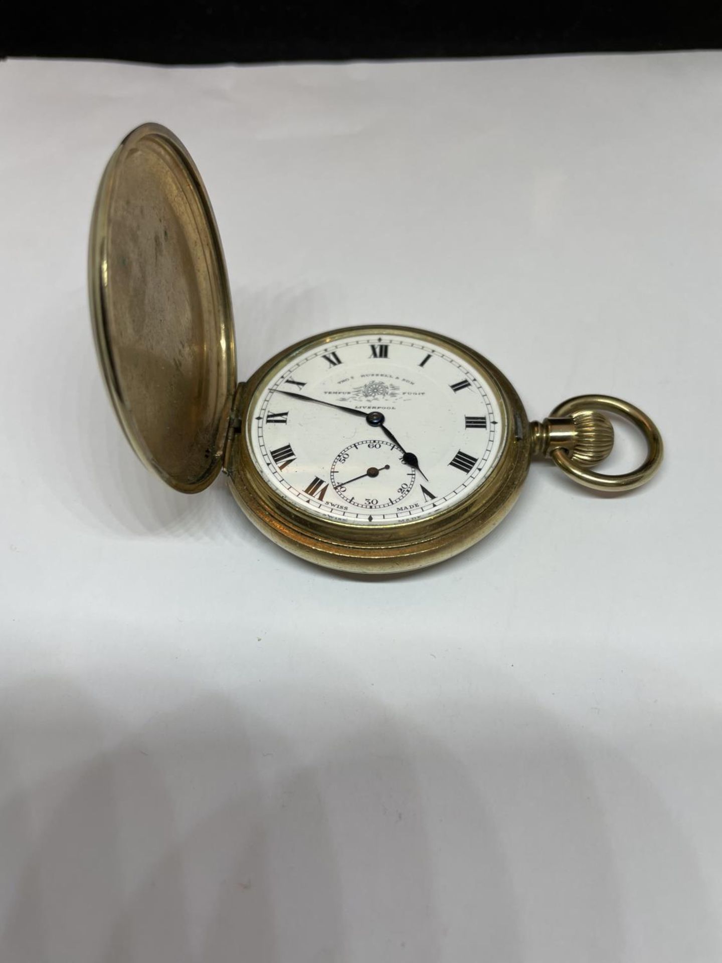 A GOLD PLATED THOS RUSSELL AND SON LIVERPOOL POCKET WATCH SEEN WORKING BUT NO WARRANTY IN A