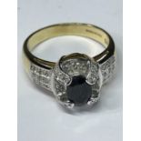A 9 CARAT GOLD ART DECO STYLE RING WITH CLEAR STONE POSSIBLY DIAMOND CHIPS SURROUNDING A CENTRE