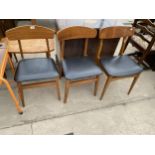 THREE RETRO TEAK DINING CHAIRS WITH WHALE FIN BACKS AND BLACK FAUX LEATHER SEATS