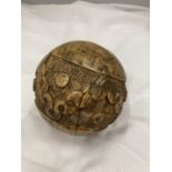 A CARVED WOODEN BALL