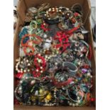 A LARGE BOX OF COSTUME JEWELLERY TO INCLUDE BANGLES, BEADS, NECKLACES, ETC
