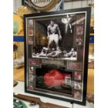 A FRAMED AND SIGNED MUHAMMAD ALI BOXING GLOVE WITH PHOTOGRAPHS, QUOTES AND HISTORY CERTIFICATE OF