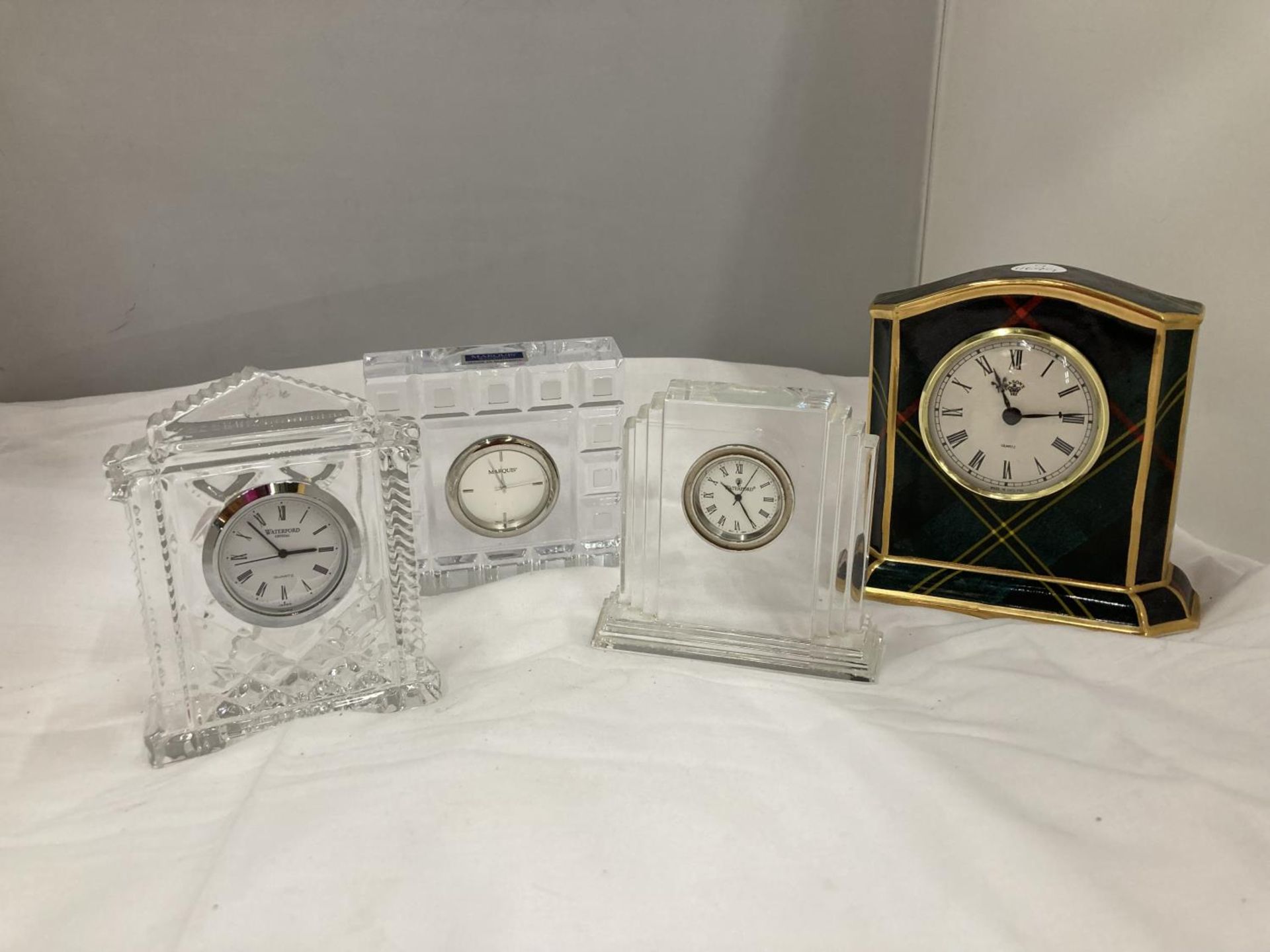 FOUR SMALL MANTLE CLOCKS TO INCLUDE A TARTAN MASONS BY WEDGWOOD AND THREE WATERFORD CRYSTAL ONES