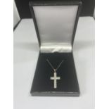 A 9 CARAT GOLD CHAIN WITH A CROSS PENDANT WITH POSSIBLY DIAMOND CHIPS GROSS WEIGHT 1.3 GRAMS IN A