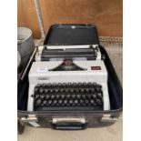 A VINTAGE AND RETRO ERIKA TYPEWRITER WITH CARRY CASE